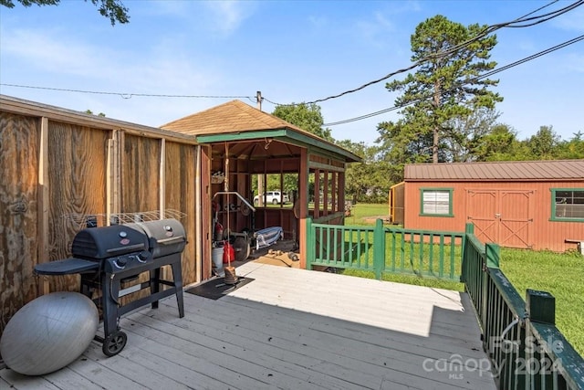 deck with a lawn and an outdoor structure