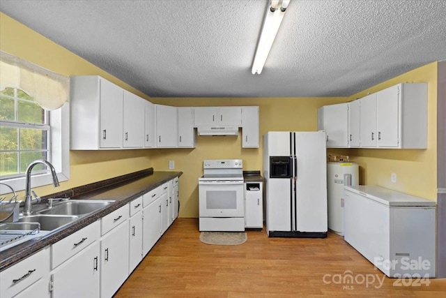 kitchen with sink, white appliances, light hardwood / wood-style floors, and white cabinetry