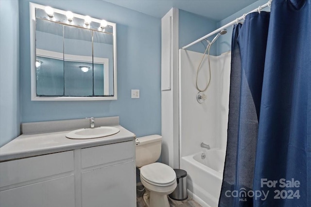 bathroom with vanity, shower / bath combo with shower curtain, and toilet