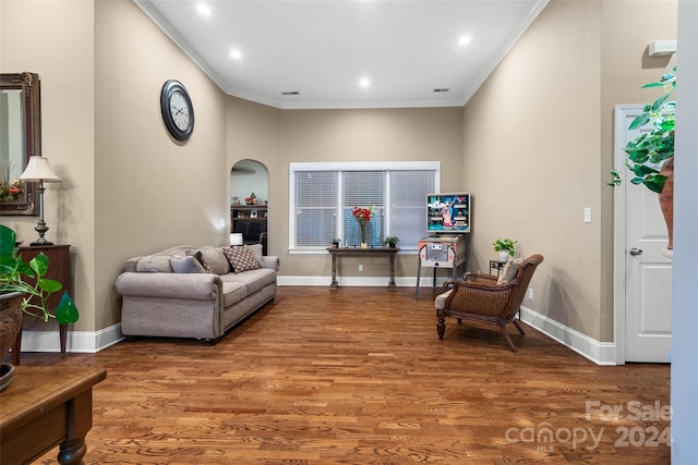 sitting room with crown molding and wood-type flooring