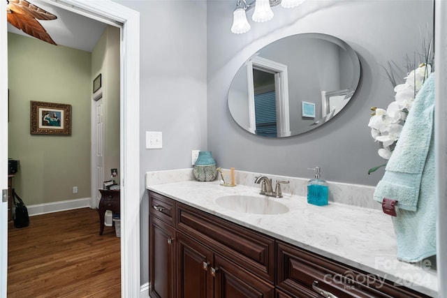 bathroom featuring ceiling fan, wood-type flooring, and vanity