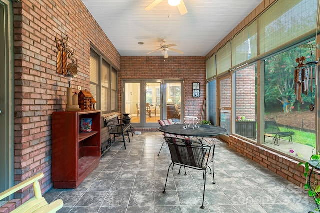 sunroom with ceiling fan and french doors