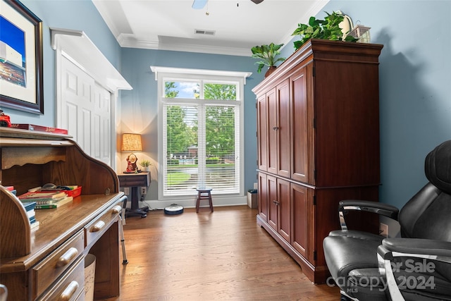 living area with ceiling fan, hardwood / wood-style floors, and crown molding