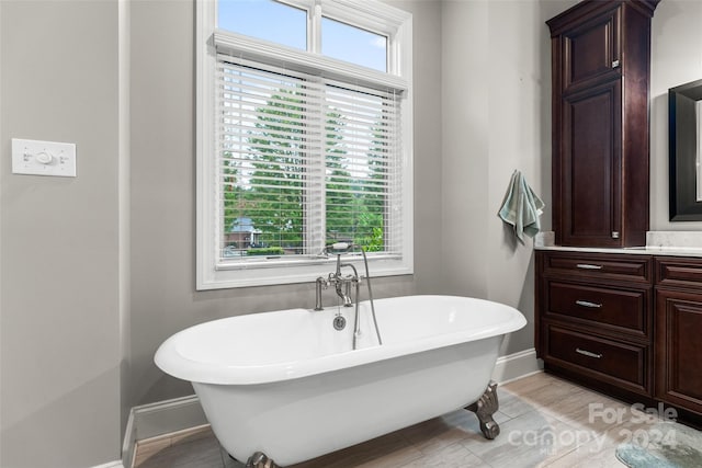 bathroom with a washtub and tile patterned flooring