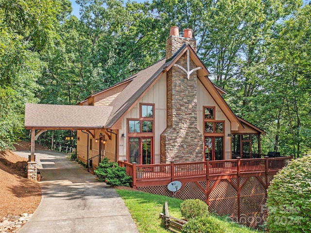 view of front facade with a wooden deck and a carport