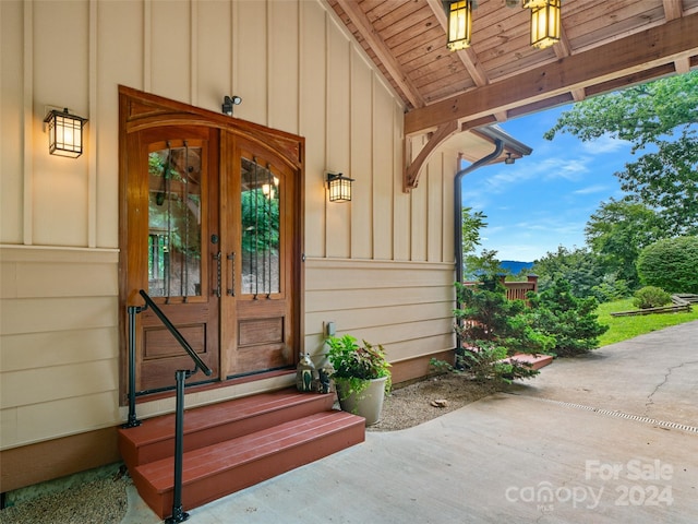 doorway to property with board and batten siding and french doors