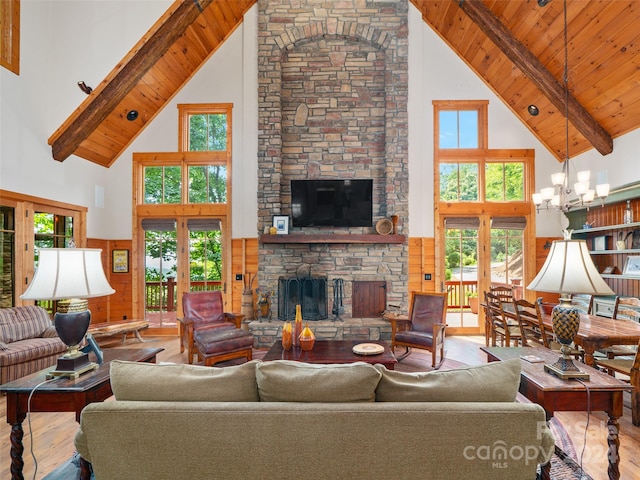 living room featuring light wood-type flooring, high vaulted ceiling, beamed ceiling, and french doors