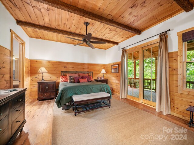 bedroom with light hardwood / wood-style floors, access to exterior, beamed ceiling, and ceiling fan