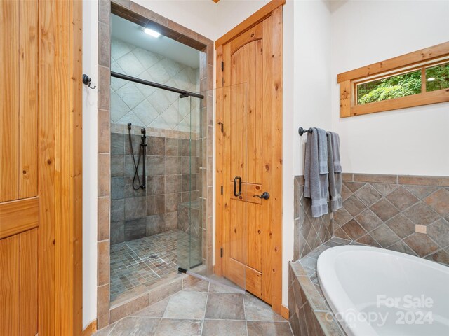 bathroom with separate shower and tub