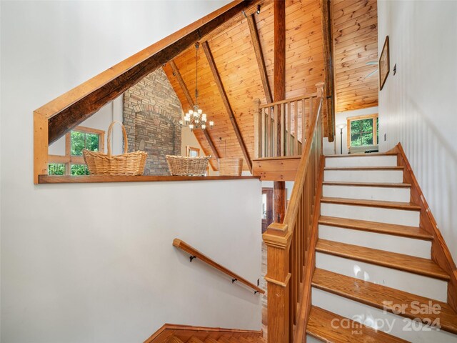 stairs featuring high vaulted ceiling, a chandelier, beamed ceiling, and wooden ceiling