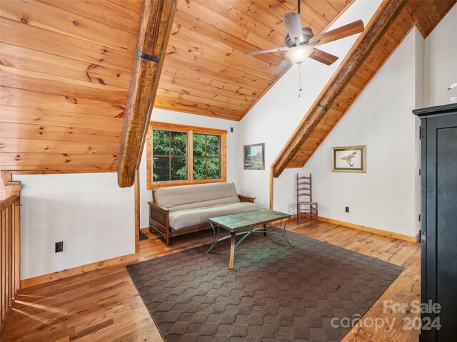 living area featuring ceiling fan, light hardwood / wood-style floors, wooden ceiling, and vaulted ceiling