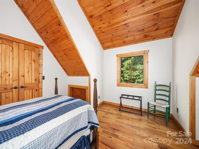 bedroom featuring light wood-type flooring, wooden ceiling, and vaulted ceiling