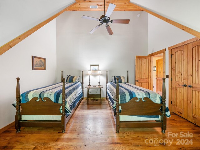 bedroom featuring ceiling fan, high vaulted ceiling, and hardwood / wood-style flooring