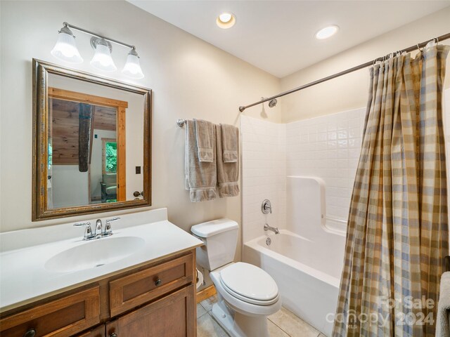 full bathroom featuring tile patterned flooring, vanity, toilet, and shower / bath combo with shower curtain