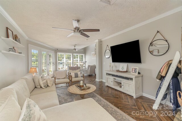 living room featuring ornamental molding, dark parquet flooring, french doors, a textured ceiling, and ceiling fan