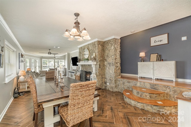 dining area with ornamental molding, dark parquet flooring, a fireplace, a textured ceiling, and ceiling fan with notable chandelier