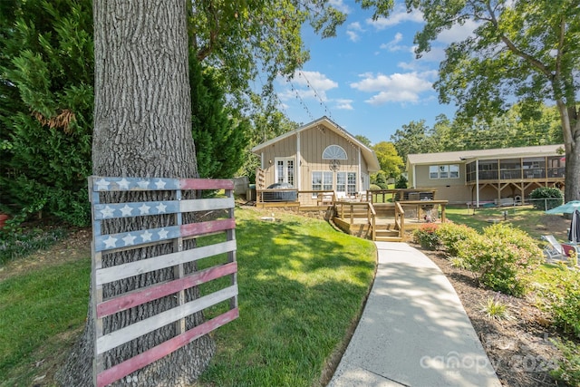 surrounding community with a wooden deck and a yard