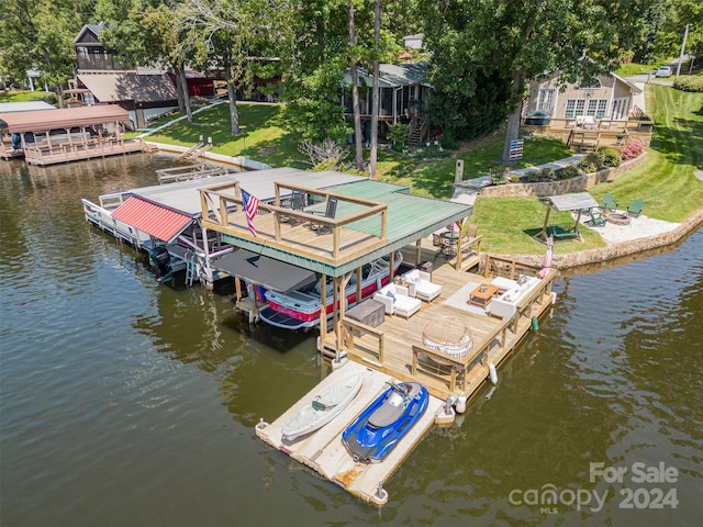 dock area with a yard and a water view