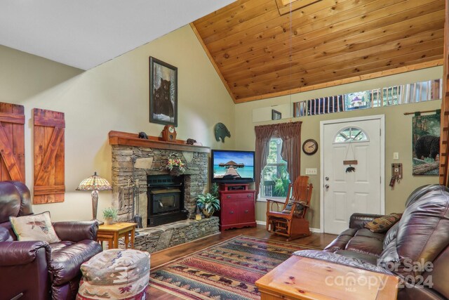 living room featuring wood ceiling, a stone fireplace, dark wood-type flooring, and high vaulted ceiling