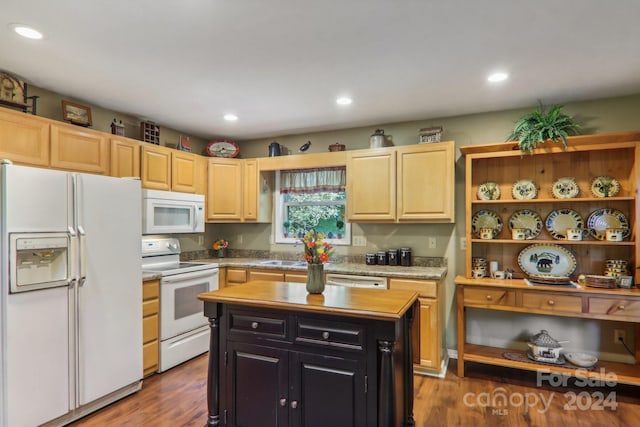 kitchen with a kitchen island, light brown cabinetry, wood-type flooring, sink, and white appliances