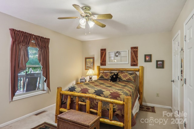 bedroom with carpet floors, visible vents, ceiling fan, and baseboards