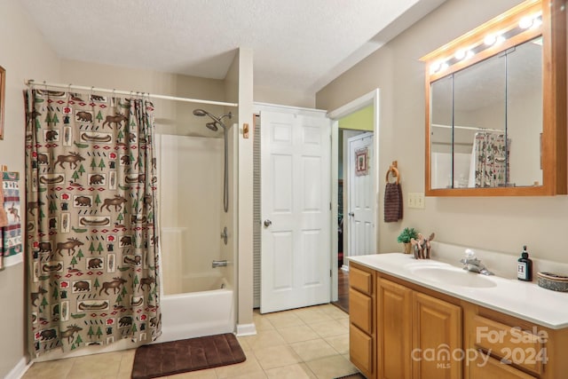 full bathroom with a textured ceiling, shower / bath combination with curtain, vanity, and tile patterned floors