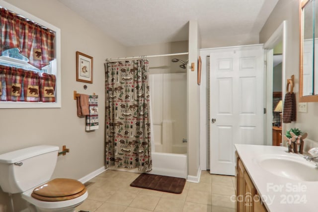 full bathroom featuring tile patterned flooring, a textured ceiling, vanity, and shower / tub combo with curtain