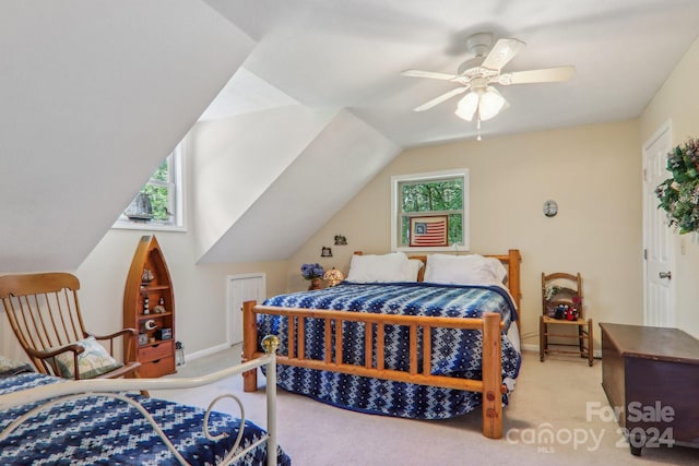 bedroom featuring lofted ceiling, baseboards, a ceiling fan, and light colored carpet