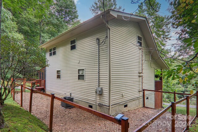 view of side of property with central AC unit