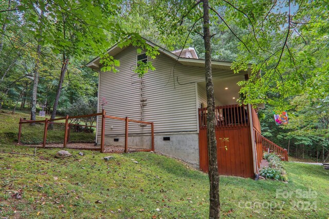 view of property exterior with a lawn