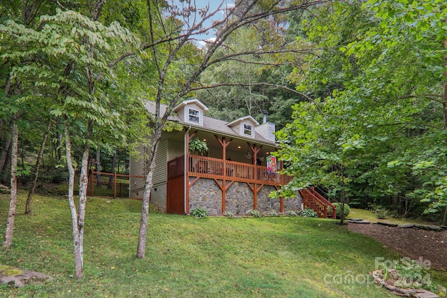 view of front of home with a front lawn and a wooden deck