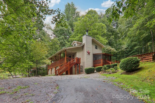 view of side of home with a sunroom