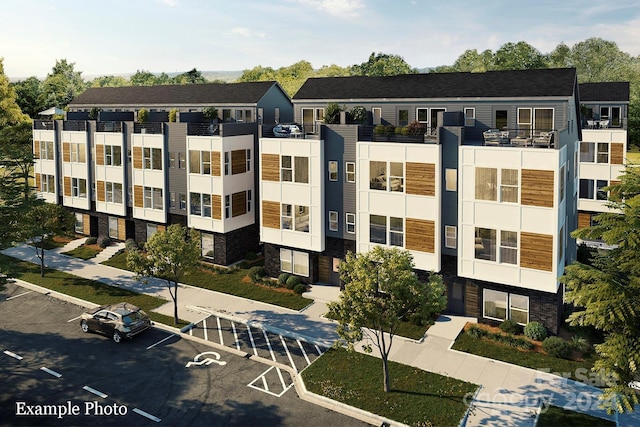 view of property featuring uncovered parking
