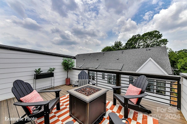 wooden deck with a fire pit