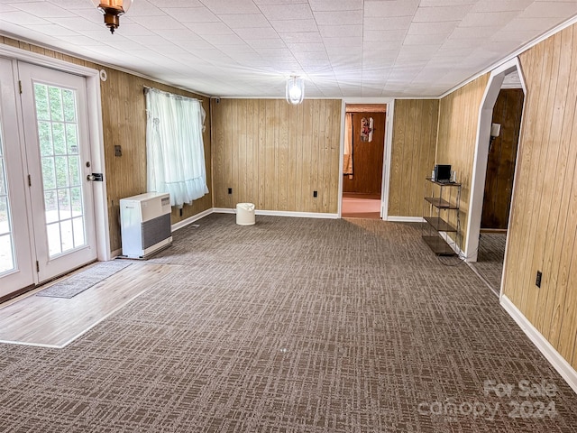 interior space featuring wood walls and heating unit