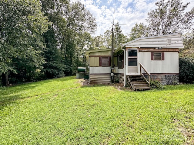 rear view of house with a yard