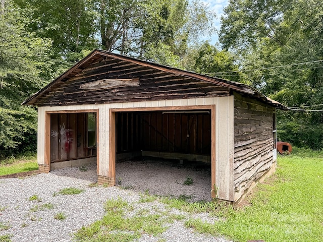 view of outbuilding featuring a lawn