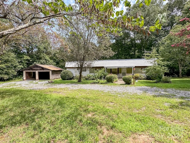 exterior space with a front lawn and an outbuilding