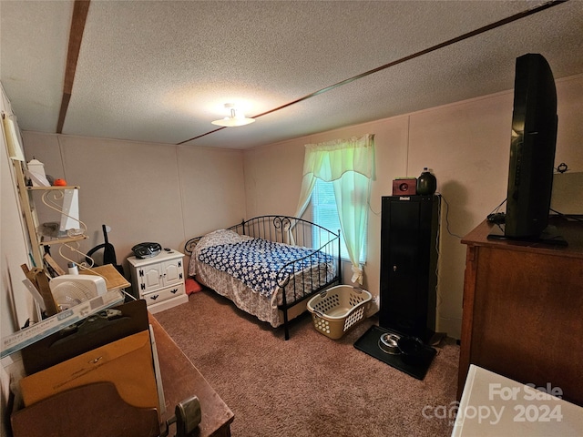 carpeted bedroom featuring a textured ceiling