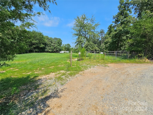 view of yard featuring a rural view and fence