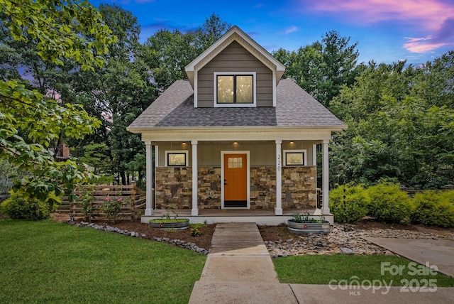 view of front of home with a lawn and a porch