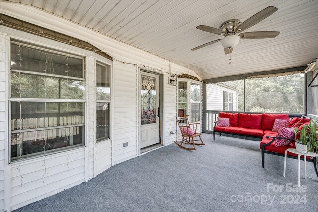 sunroom featuring lofted ceiling, wood ceiling, and ceiling fan