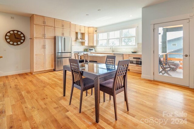 dining area featuring light hardwood / wood-style flooring and sink