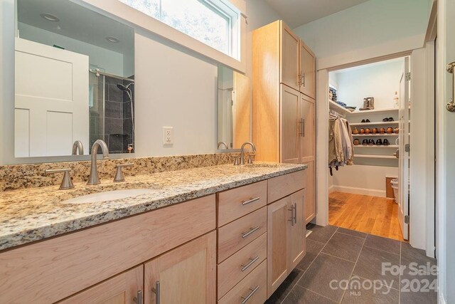 bathroom with an enclosed shower, vanity, toilet, and hardwood / wood-style flooring