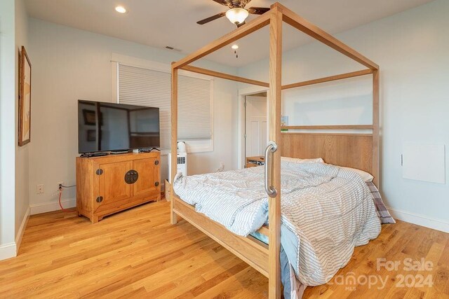 bedroom with light hardwood / wood-style flooring and ceiling fan