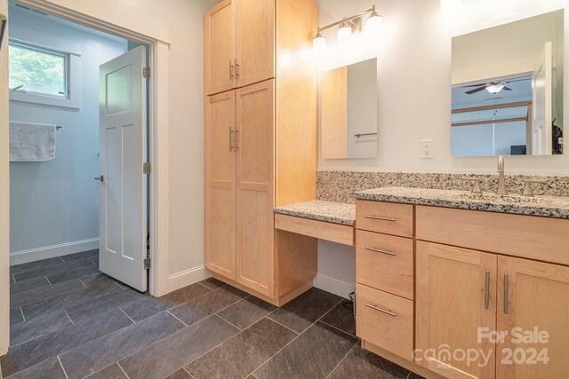 bathroom with ceiling fan, vanity, and tile patterned flooring