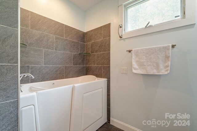 bathroom with a tub to relax in