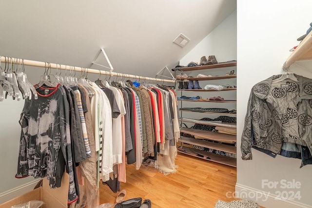 spacious closet featuring hardwood / wood-style flooring and lofted ceiling