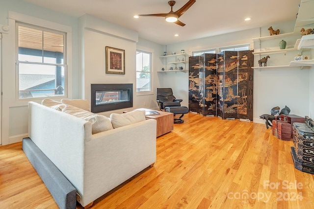 living room featuring ceiling fan and hardwood / wood-style flooring