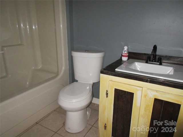 bathroom featuring tile patterned flooring, vanity, and toilet